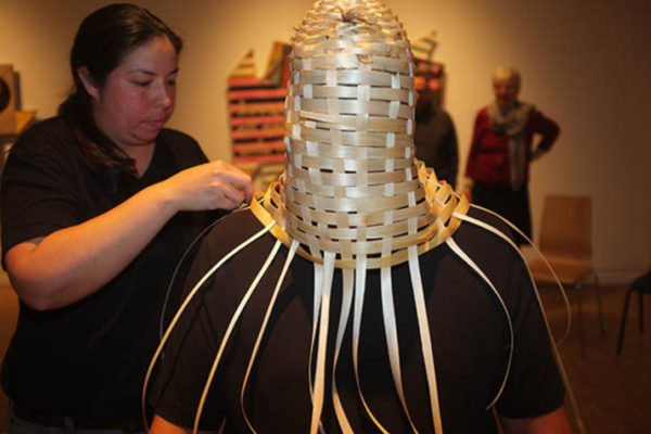 Ursula Johnson weaves a basketry portrait bust on a volunteer at MSVU Art Gallery. The work is part of the series K’nuwelti’k (We Are Indian) - (2014)